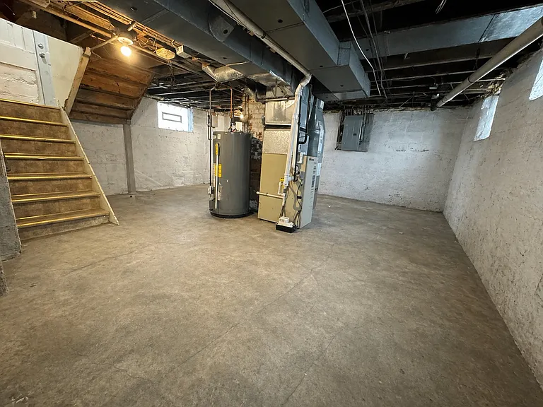 Clean and functional basement with a newly installed boiler for efficient heating. Offers ample space for storage along with convenient laundry hookups, making it a practical extension of the home for organization and everyday use.