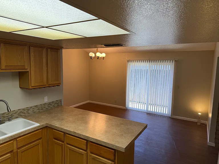 Kitchen looks into Dining / office room with slider to sideyard and backyard