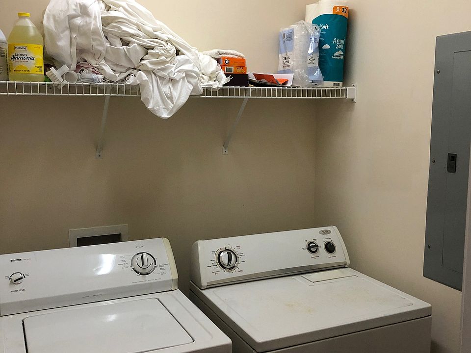Laundry room with washer and dryer and breaker panel.