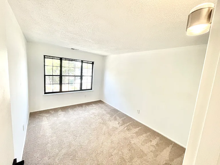 Second bedroom with a large window