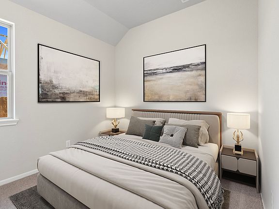 The secondary bedroom features plush carpet, fresh paint, closet, and a large window that lets in pl