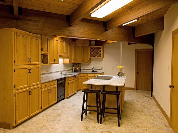 New granite tops island & quartz counters wrap the kitchen.