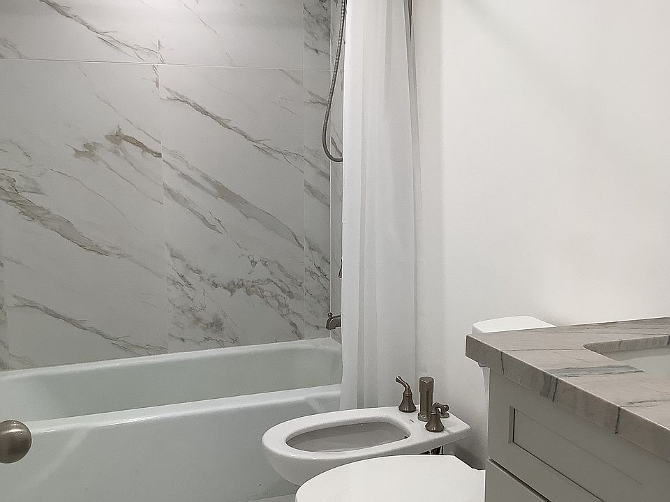 Tub, bidet, toilet, vanity.