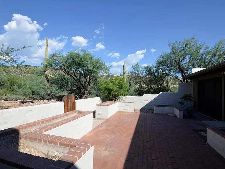 Private patio with green space on two sides