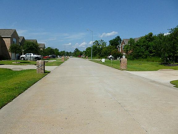 Standing in front of the lot and looking the other way down the street.