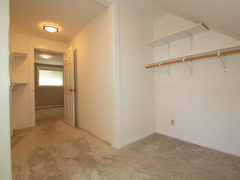 Walk in closet in small upstairs bedrrom