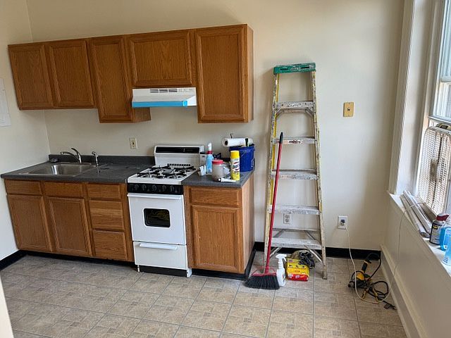 kitchen, gas stove, wooden cabinet
windows with screen facing East.