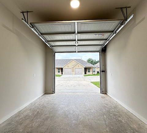 Spacious Garage with driveway behind.
