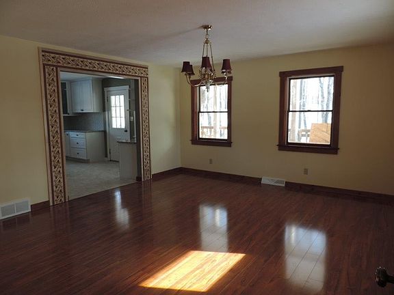 Gorgeous Dining Room with Decorative Entrance into Kitchen