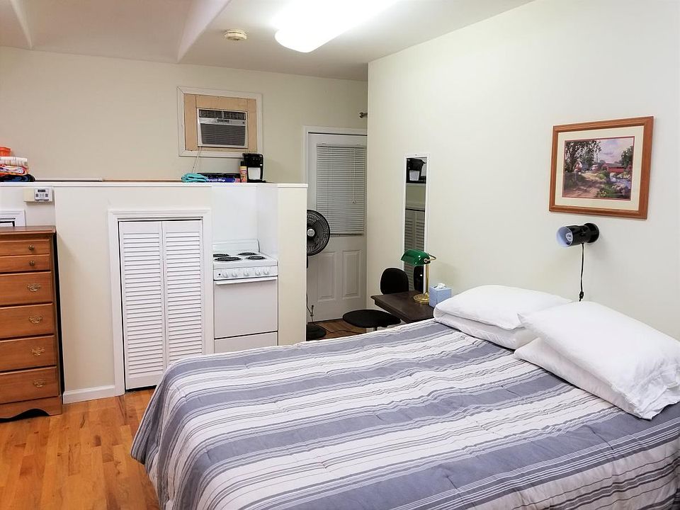 Bed, looking toward rear of studio.