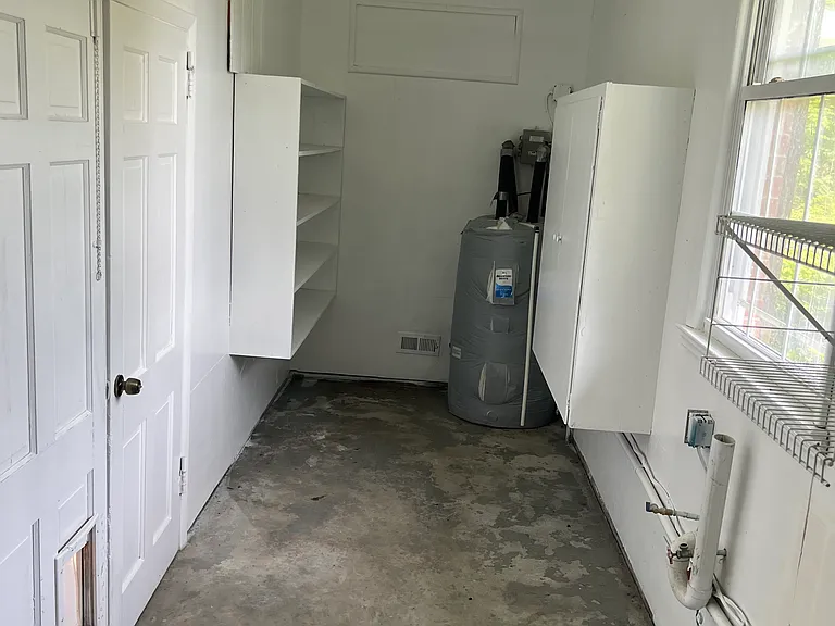 Outside storage and washer/dryer hookups off of carport