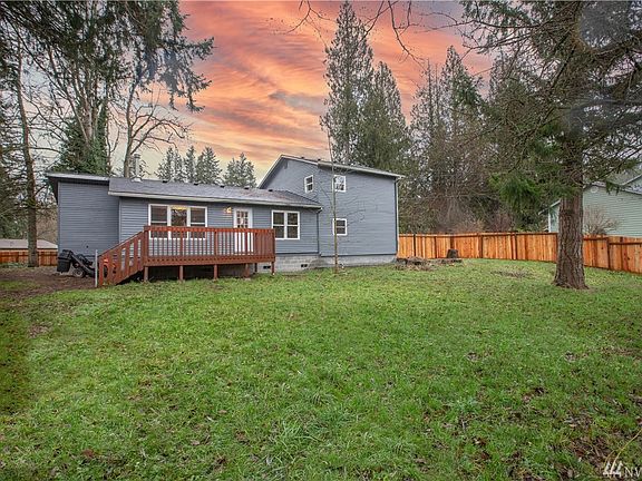 Rear shot of home, nice deck off the back, new fence and large, flat yard. 