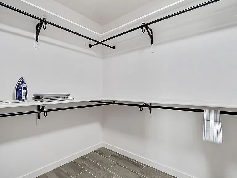 Spacious closet with hooks, iron and ironing board!