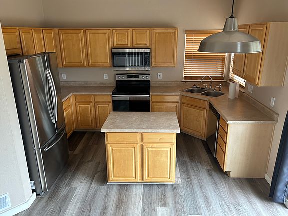 Kitchen includes newer refrigerator, microwave, cooktop/oven