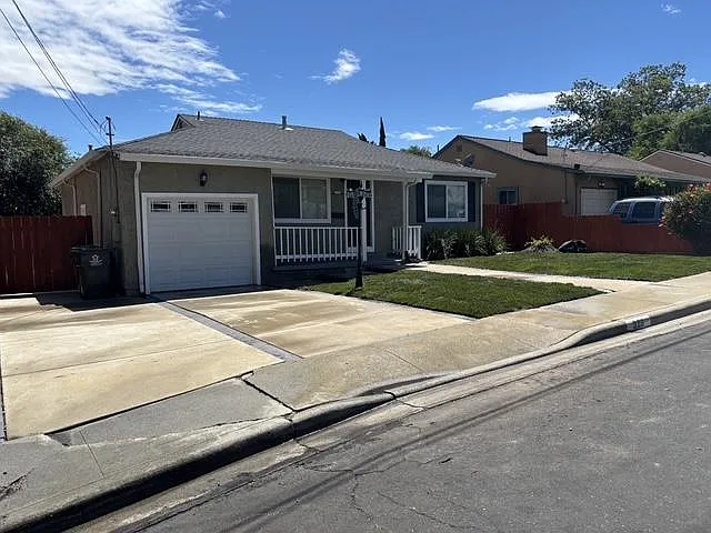Street view of Front of home. Large driveway and single car garage with remote control garage opener.