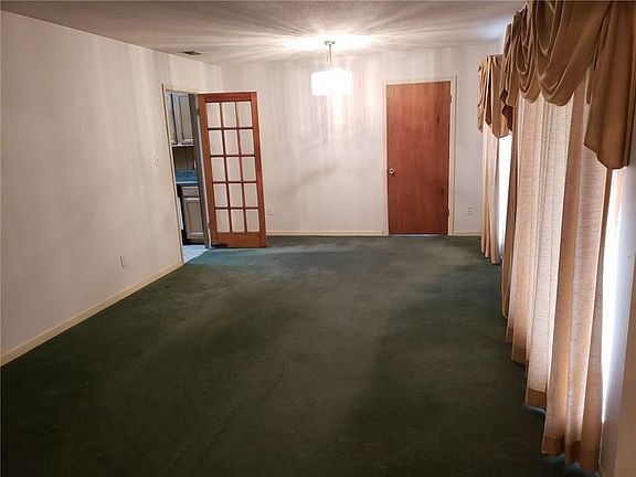 Living room/ dining combination (solid door lead to den)