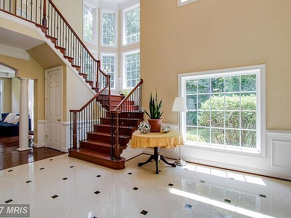 Marble Foyer w/Wrought Iron Rail Stairway