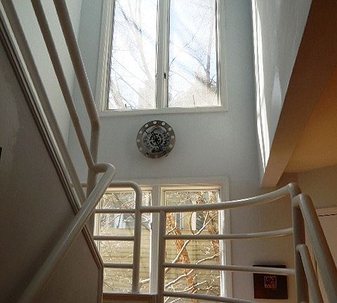 Soaring ceilings in this entry foyer and stairs