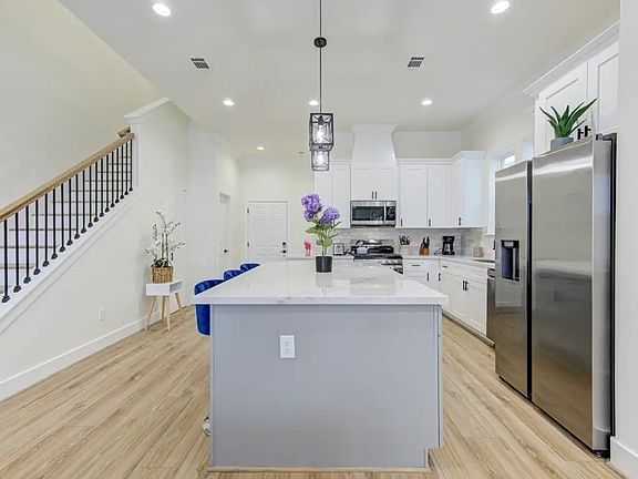 full kitchen and staircase