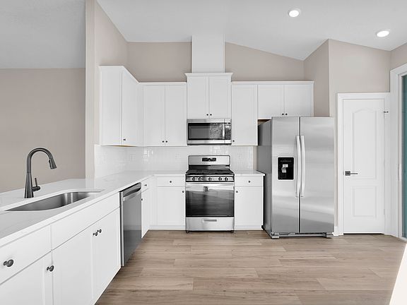 The spacious kitchen offers plenty of counter space, perfect for cooking and entertaining.