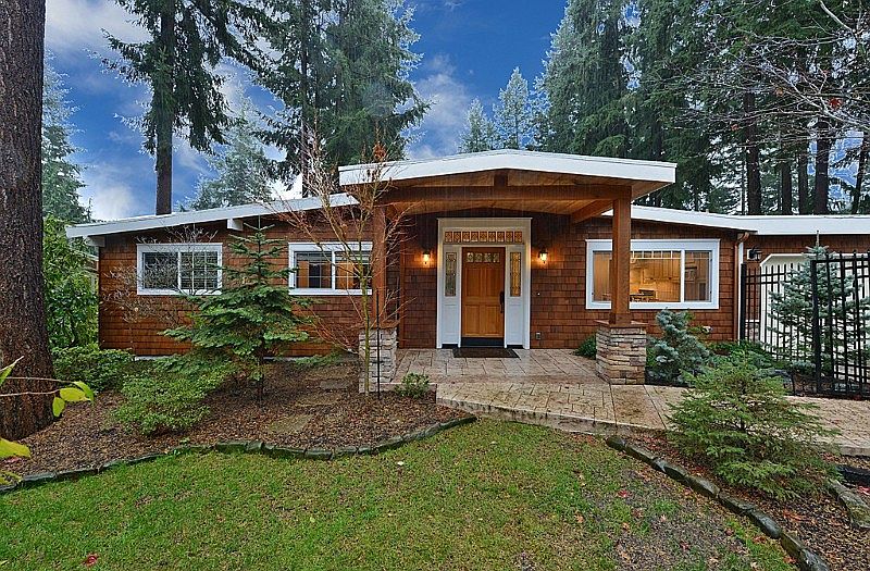 View of the entry and the front of the house. Gated entry with stamped concrete. The main entrance to the house is cover by a decent size overhang to keep you and your guest out of the elements. Landscaped front yard with a path to the back yard.