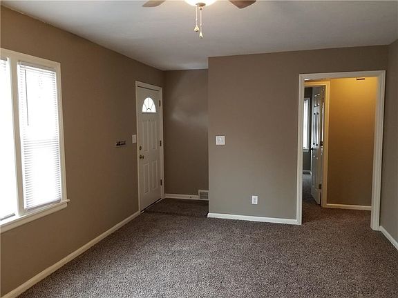 Additional entrance to front of home with large deck
