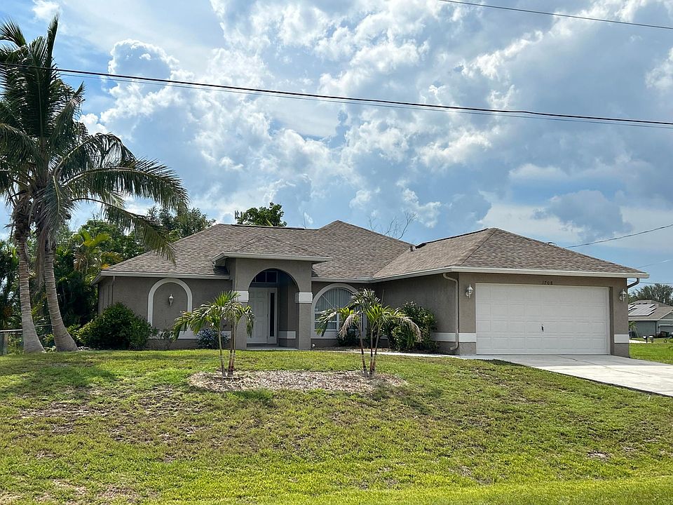 Front view shows house sits high off the street with good drainage.