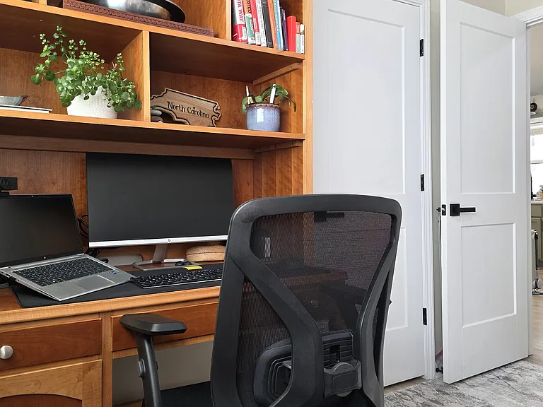 This office set-up is perfect for remote work, with plenty of natural light and privacy/separation from the main living area.