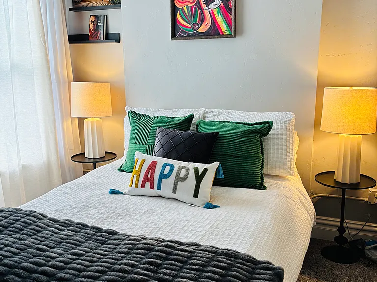 The second bedroom is a beautifully designed, well-utilized space that feels both inviting and functional. Featuring a brand-new, never-used bed and mattress dressed in luxury bedding, it offers exceptional comfort.