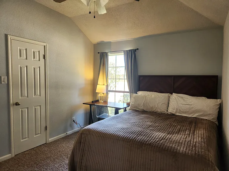 Queen bed, dresser, window view desk with chair, closet.