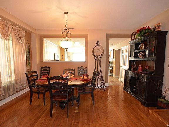 Formal dining area with wood flooring