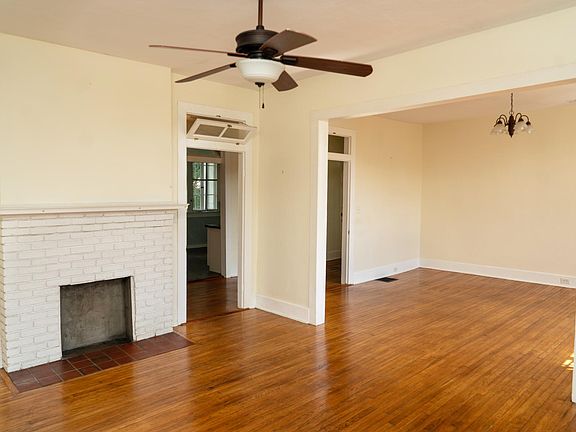 living room with fireplace, looking into dining room