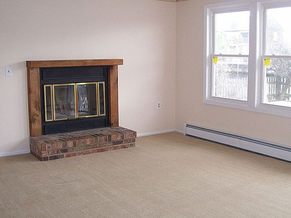 Woodburning Fireplace in Living Room with slider to rear yard