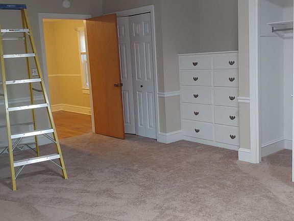 Master bedroom with two closets and built in dresser.
