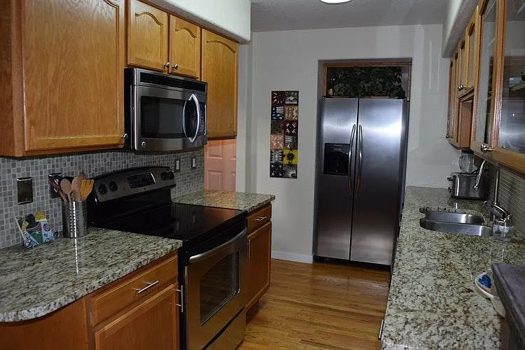 Kitchen with stainless appliances and granite counters
