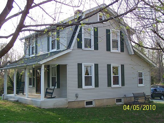 To the left of the front