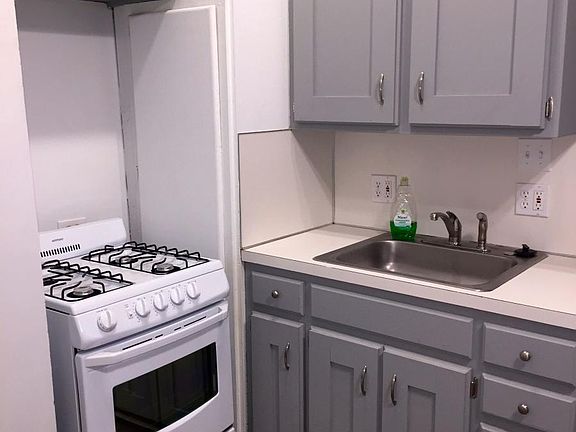 New gas-top range, faucet and cabinet hardware.