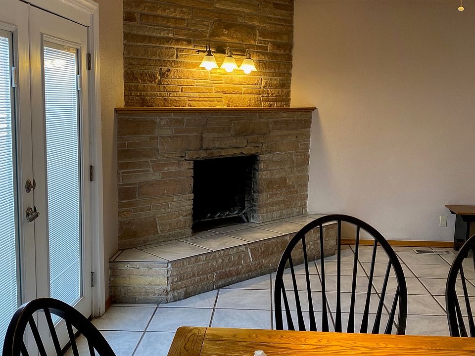 A unit Living room's fireplace with door to back yard