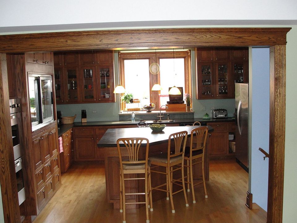 Kitchen with black counter tops & maple flr. 