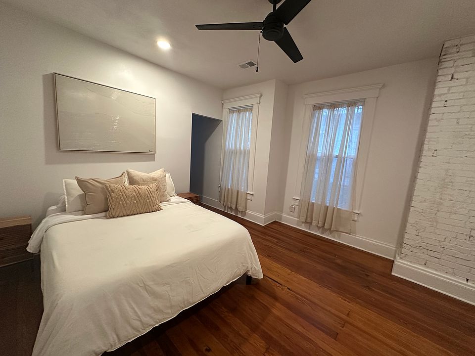 Private bedroom with keyed lock. Furnished with queen bed, bedding and (2) side tables.