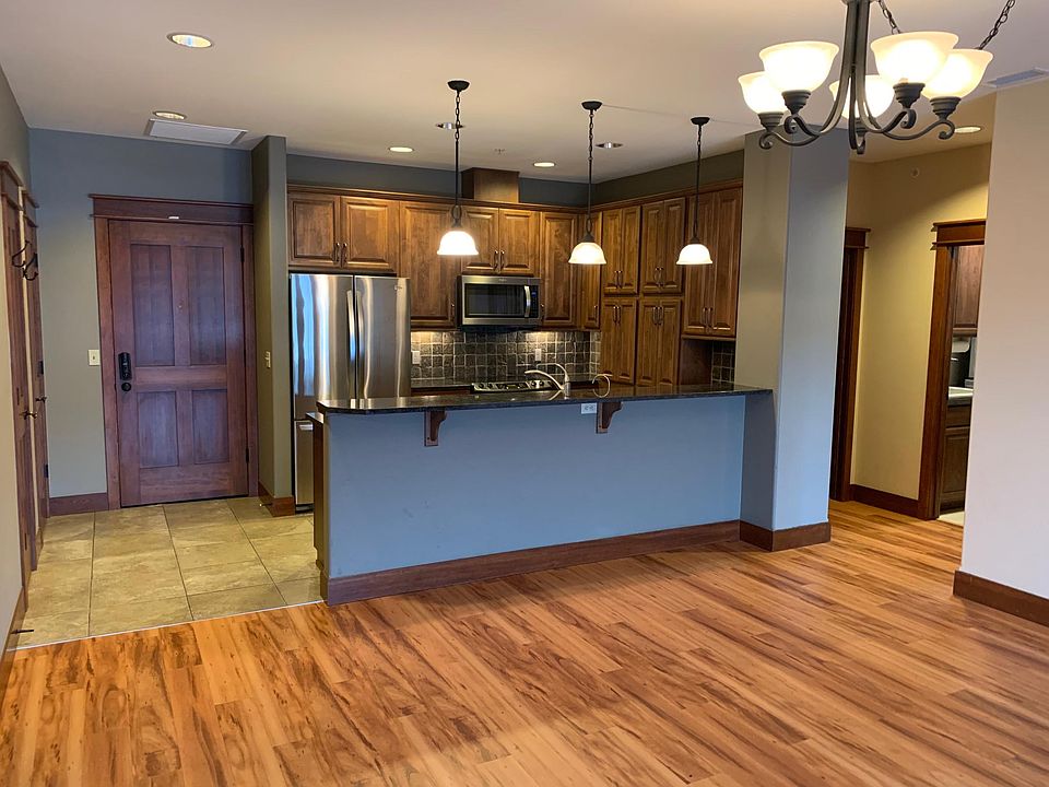 Spacious kitchen with upgraded appliances and bar for seating