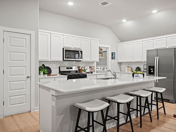 Kitchen in the Diamond home plan by Trophy Signature Homes - REPRESENTATIVE PHOTO