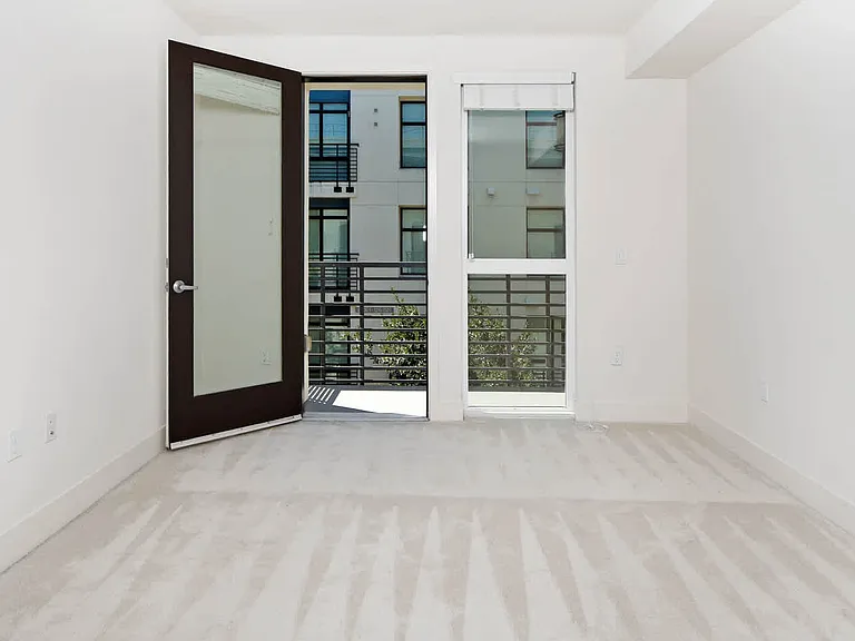 Carpeted Bedroom with Balcony