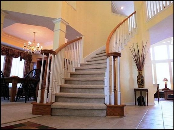 Curved staircase with wood spindles. Lots of architectural details!