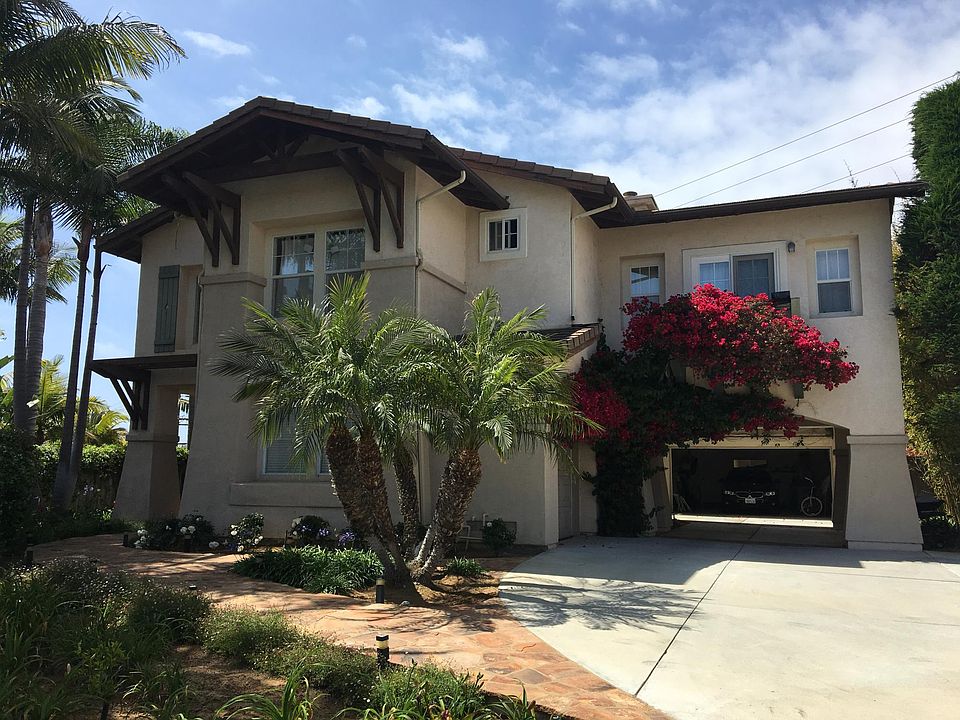 House front - palms, bougainvillea, port-cochere to garage
