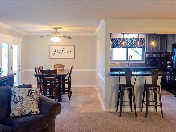 The open floor plan is great for entertaining. With fresh paint, custom molding, updated fixtures, newer flooring, and an update