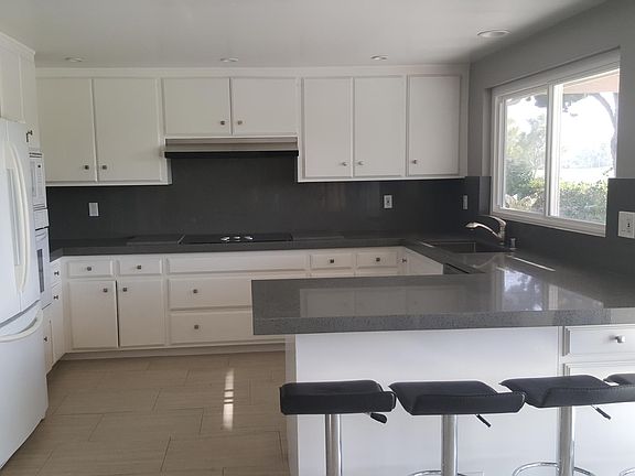 Kitchen with new quartz counters, counter seating with stool