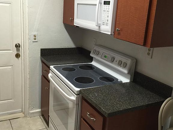 glass-top stove/built-in microwave in updated kitchen