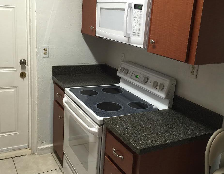 glass-top stove/built-in microwave in updated kitchen