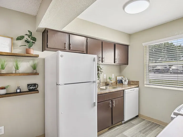 One bedroom kitchen with large window and dishwasher.